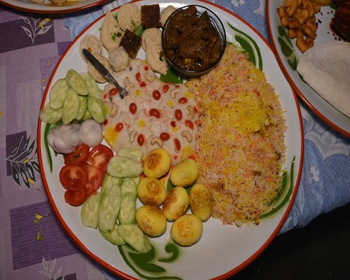 A plate of colorful mixed rice with vegetables and proteins