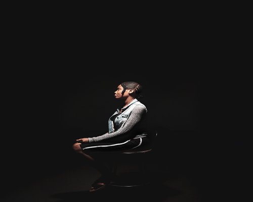 Person doing a light shoulder stretch while sitting on a chair